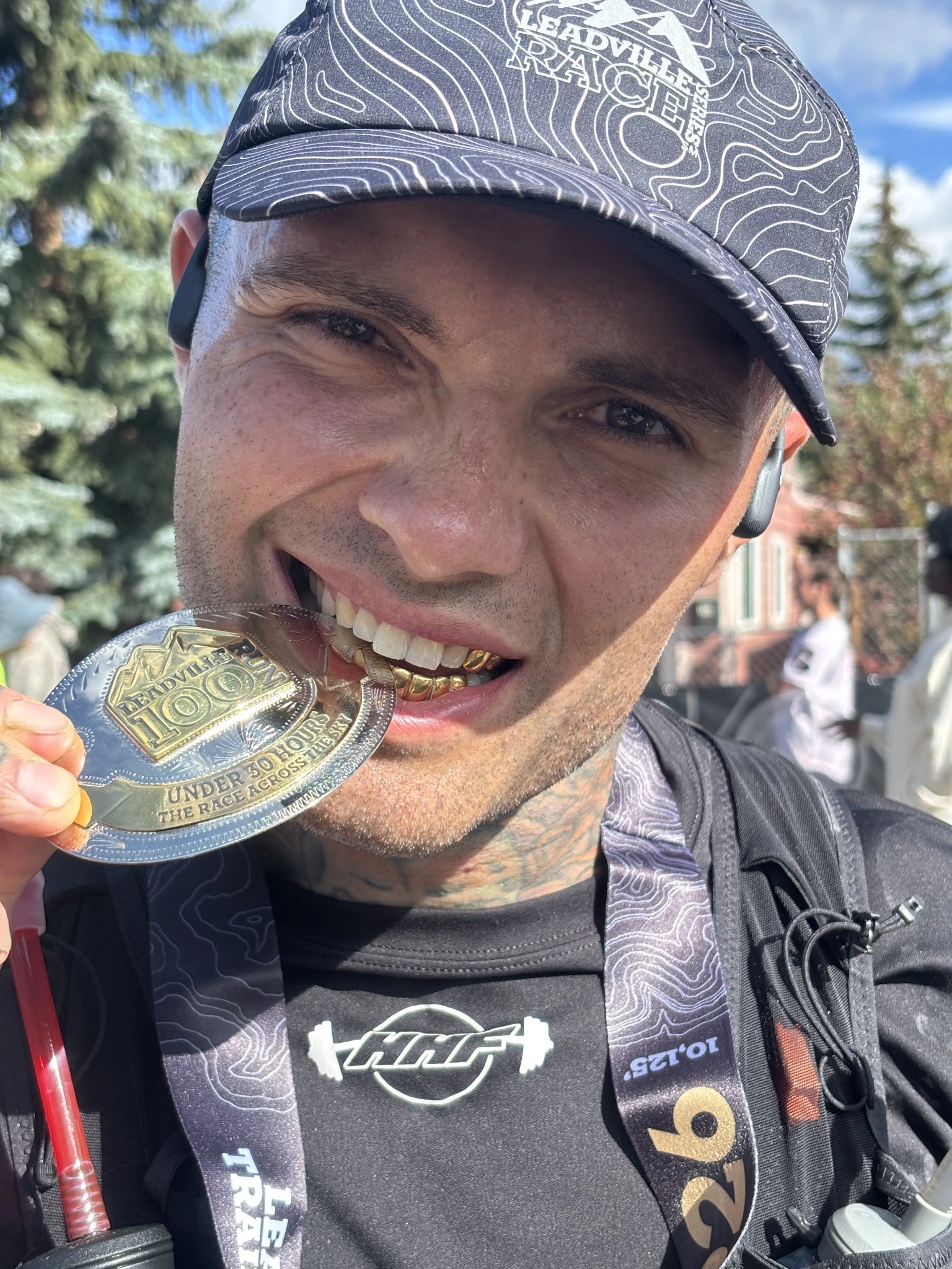 Kenny celebrating his finish by biting his medal.