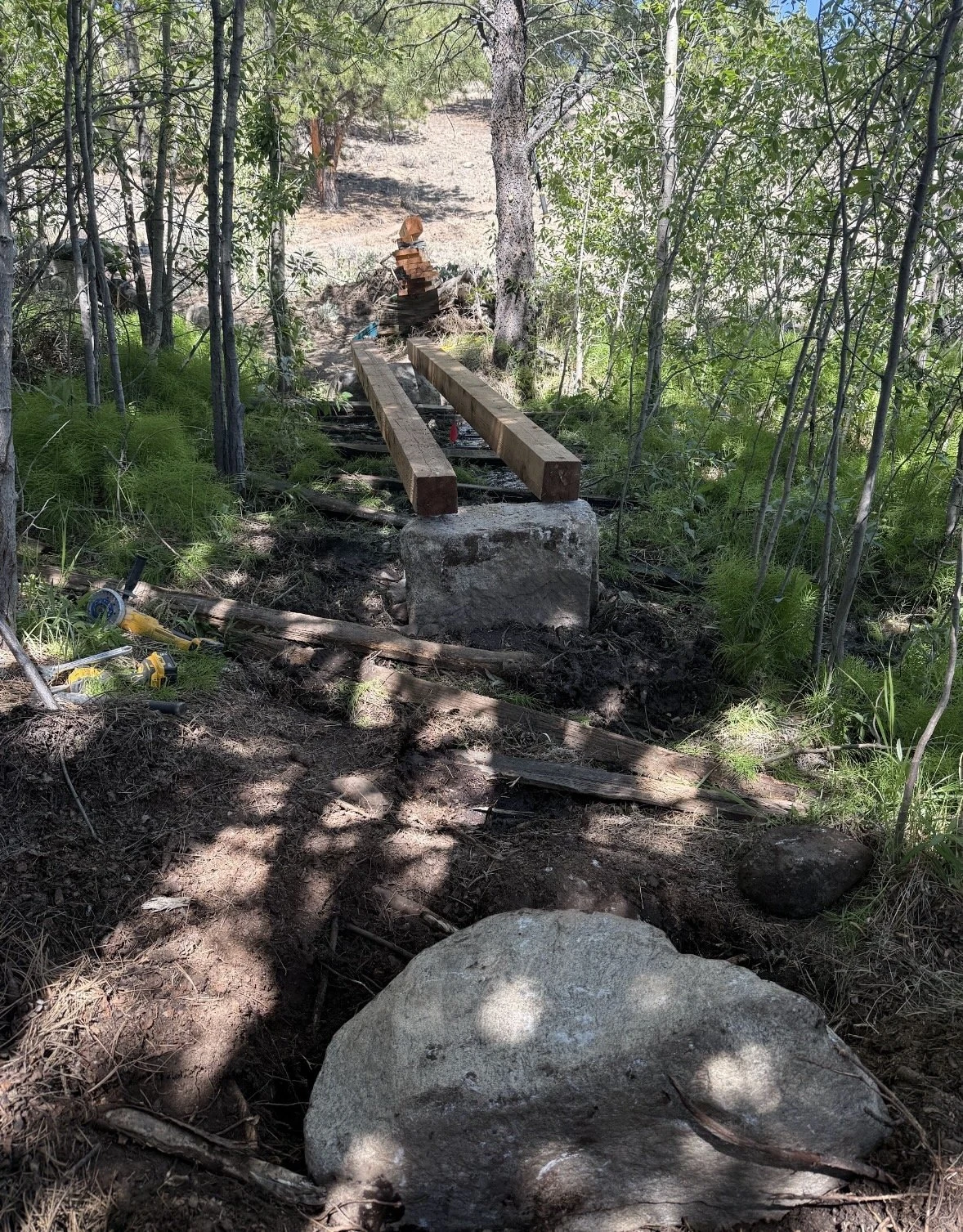 Twin Lakes Connector bridge under construction among trees
